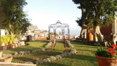 a garden with a gazebo in a city at Romantic Studio in Funchal