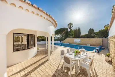 a patio with a table and chairs next to a pool at Fortaleza sea view Villa Miramar - Apartment with private pool in Budens