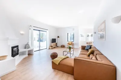a living room with a couch and a fireplace at Fortaleza sea view Villa Miramar - Apartment with private pool in Budens