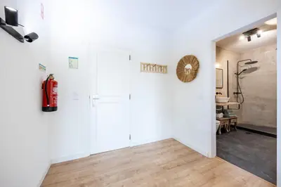 a living room with white walls and wooden floors at Fortaleza sea view Villa Miramar - Downstairs Apartment in Burgau