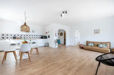 a kitchen and living room with a table and a couch at Fortaleza sea view Villa Miramar - Downstairs Apartment in Burgau