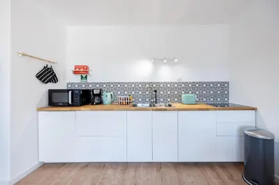 a kitchen with white cabinets and a counter top at Fortaleza sea view Villa Miramar - Downstairs Apartment II in Burgau