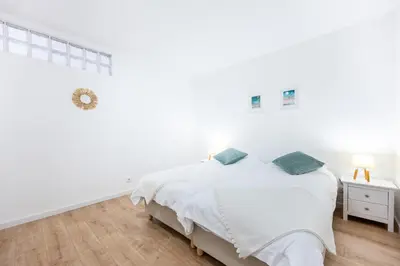 a white bedroom with a bed and a window at Fortaleza sea view Villa Miramar - Downstairs Apartment II in Burgau