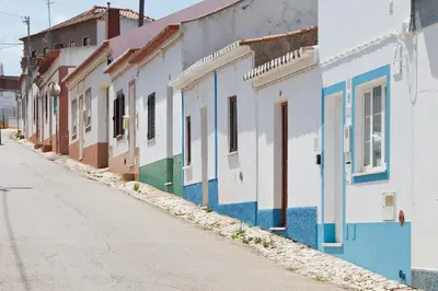 a row of colorful buildings on a street at Fortaleza sea view Villa Miramar - Downstairs Apartment II in Burgau