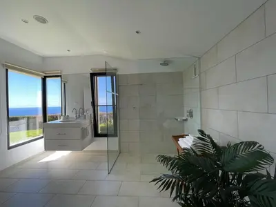 a bathroom with a tub and a sink and a toilet at Morning Star Villa in Arco da Calheta