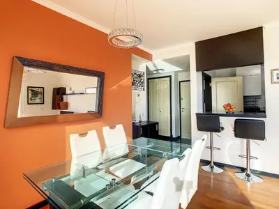 a glass dining room table with white chairs and a mirror at Rodamar Apartment by LovelyStay in Funchal