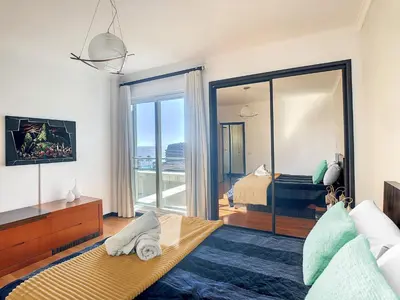 a bedroom with a bed and a view of the ocean at Rodamar Apartment by LovelyStay in Funchal