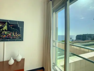 a room with a window and a view of a building at Rodamar Apartment by LovelyStay in Funchal