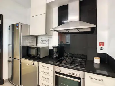 a kitchen with a stainless steel stove and refrigerator at Rodamar Apartment by LovelyStay in Funchal