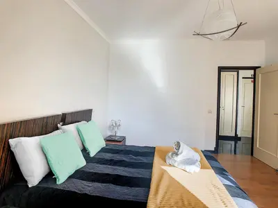 a bedroom with a bed with green and white pillows at Rodamar Apartment by LovelyStay in Funchal