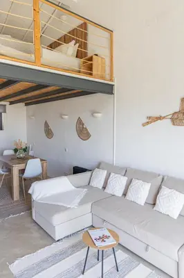 a living room with a couch and a loft at Casa Nook Sagres in Vila do Bispo