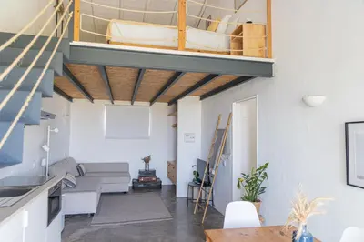 a living room with a couch and a boat on the ceiling at Casa Nook Sagres in Vila do Bispo