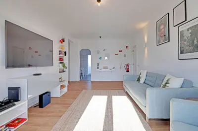 a living room with a couch and a flat screen tv at Sea Salt, Sagres Apartment in Sagres