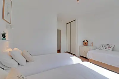a white bedroom with two beds and a mirror at Sea Salt, Sagres Apartment in Sagres