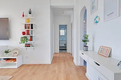 a living room with white walls and wooden floors at Sea Salt, Sagres Apartment in Sagres