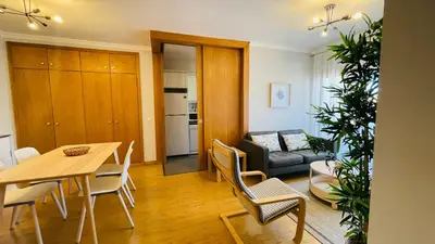 a living room with a table and chairs and a couch at Anadia Chic Apartment in Funchal