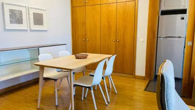 a dining room with a table and white chairs at Anadia Chic Apartment in Funchal