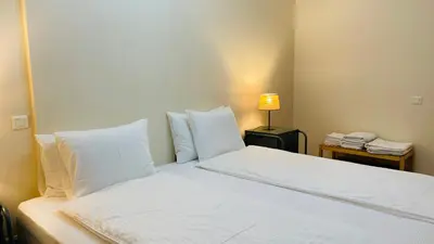 a bed with white sheets and pillows in a room at Anadia Chic Apartment in Funchal