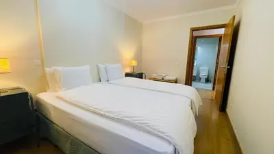 a large white bed in a room with a mirror at Anadia Chic Apartment in Funchal