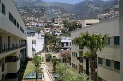 a view of a city from between two buildings at Anadia Chic Apartment in Funchal