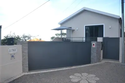 a house with a black gate and a fence at Casa d' Avó Zeza in Jardim do Mar