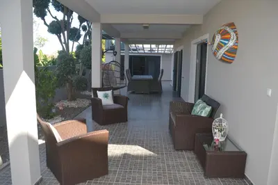 a porch with couches and chairs on a patio at Casa d' Avó Zeza in Jardim do Mar