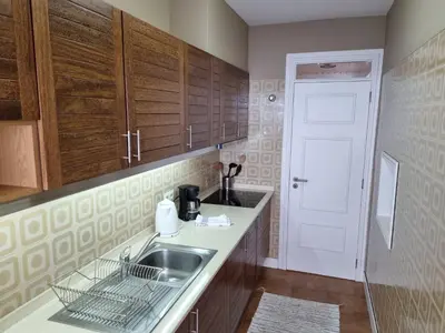 a kitchen with a sink and a white door at Ocean at your feet! in Funchal