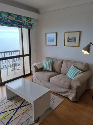 a living room with a couch and a table at Ocean at your feet! in Funchal
