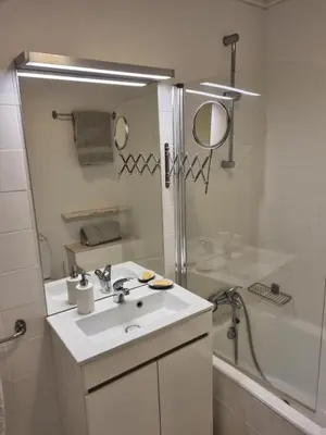 a white bathroom with a sink and a shower at Ocean at your feet! in Funchal