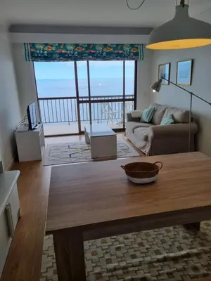 a living room with a table and a view of the ocean at Ocean at your feet! in Funchal