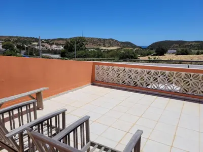 a balcony with two chairs and a tile floor at Quinta dos Moledros in Figueira
