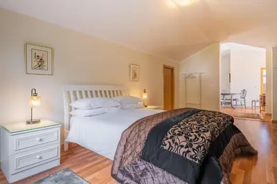 a bedroom with a bed and a table and a chair at Casa grata in Arco da Calheta