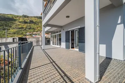 a balcony of a house with blue walls at Casa grata in Arco da Calheta