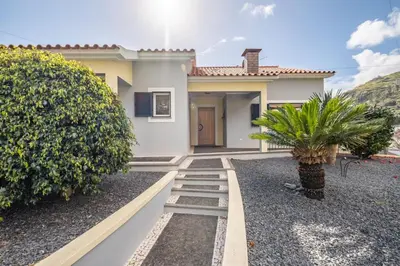 a house with a pathway leading to the front yard at Casa grata in Arco da Calheta