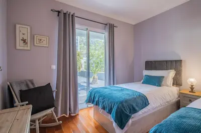 a bedroom with a bed and a window at Casa grata in Arco da Calheta
