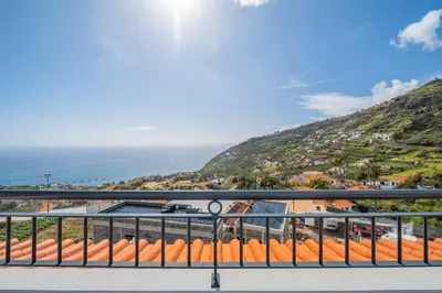 a balcony with a view of the ocean at Casa grata in Arco da Calheta