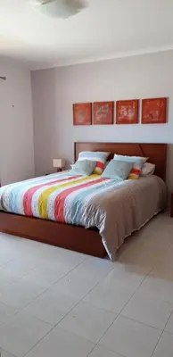 a bedroom with a bed with a colorful blanket at Superbe appartement vue sur mer à 180° Luz in Luz