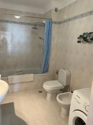 a bathroom with a toilet and a tub and a sink at Superbe appartement vue sur mer à 180° Luz in Luz