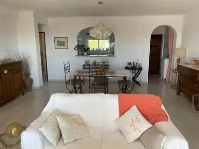 a living room with a white couch and a table at Superbe appartement vue sur mer à 180° Luz in Luz