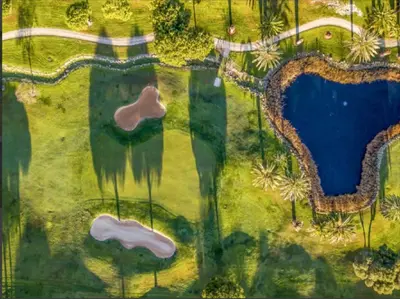 an overhead view of a golf course with a lake at WOW Flat, Birdie, Golf, Spa & Swimming Pool (WIFI) in Lagos