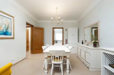 a dining room with a white table and chairs at WOW Flat, Birdie, Golf, Spa & Swimming Pool (WIFI) in Lagos