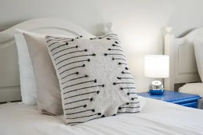 a white bed with a pillow on top of it at WOW Flat, Birdie, Golf, Spa & Swimming Pool (WIFI) in Lagos