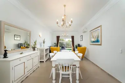 a dining room with a white table and yellow chairs at WOW Flat, Birdie, Golf, Spa & Swimming Pool (WIFI) in Lagos