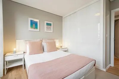 a bedroom with a large white bed with pink sheets at The Boats Apartment by An Island Apart in Funchal