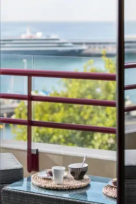 a table with two coffee cups on a balcony at The Boats Apartment by An Island Apart in Funchal