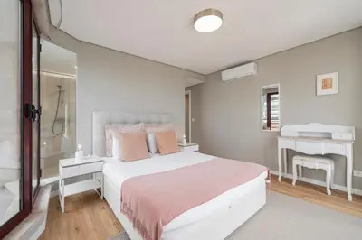 a white bedroom with a bed and a piano at The Boats Apartment by An Island Apart in Funchal