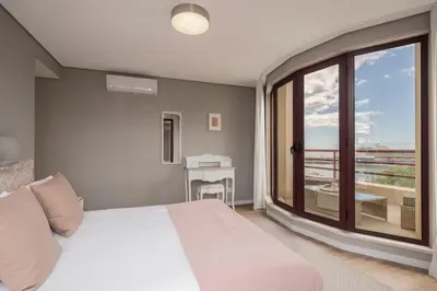 a bedroom with a bed and a view of a balcony at The Boats Apartment by An Island Apart in Funchal