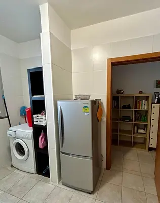 a kitchen with white cabinets and a sink and a window at Vista Dourada in Porto Santo
