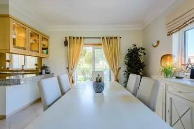 a dining room with a white table and chairs at Casa Sunny Days - Boavista Resort in Lagos
