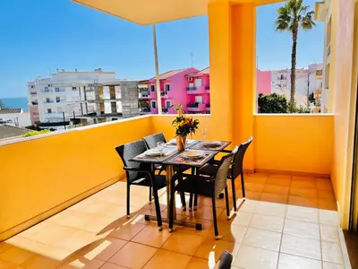 a table and chairs on a balcony with a view at Estrela da Praia da Luz - 2 Bedroom Sea View Apartment in Luz